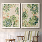 Set of two white barnwood framed canvas prints depicting two decorative botanical pattern prints featuring dense repeating succulents and small flowers above a sideboard in a cozy sitting room.