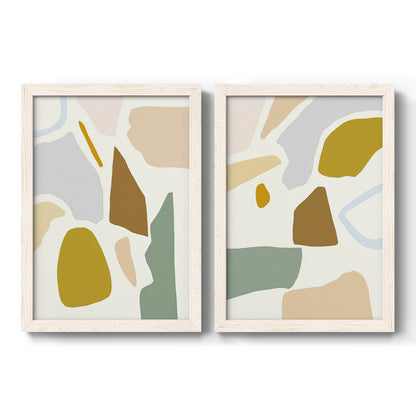 Set of two white barnwood framed canvas prints featuring two pastel geometric abstracts featuring soft mustard sage gray and white irregular shapes.