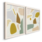 Angled view of a set of two white barnwood framed canvas prints featuring two pastel geometric abstracts featuring soft mustard sage gray and white irregular shapes.