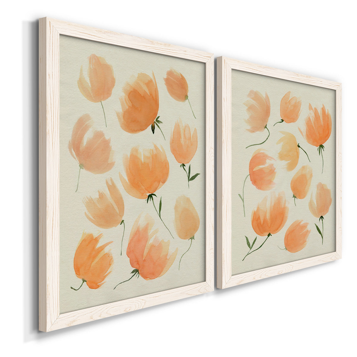 Angled view of a set of two white barnwood framed canvas prints featuring two airy watercolor floral paintings featuring loose peach-orange tulip-like blossoms.