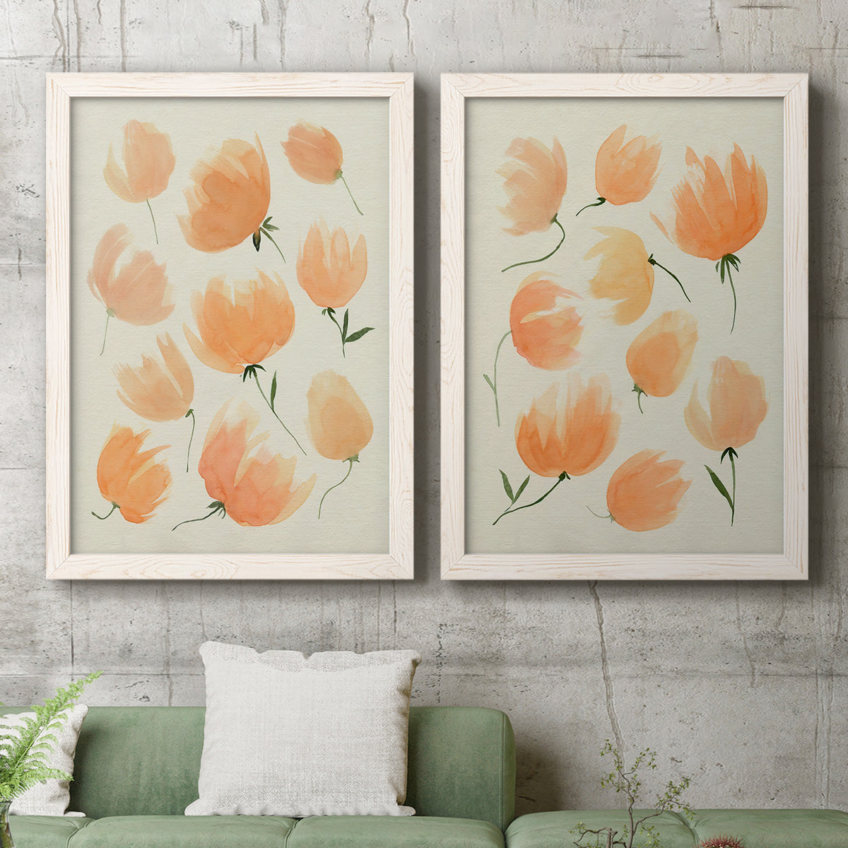 Set of two white barnwood framed canvas prints depicting a coordinated art pair of loose peach-orange tulip-like blossoms rendered as airy watercolor floral paintings above a sofa in a modern living room.