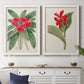 Set of two white barnwood framed canvas prints depicting a coordinated art pair of vivid tropical flowering plants rendered as antique botanical plate illustrations above a dining room sideboard.