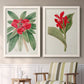Set of two white barnwood framed canvas prints depicting two antique botanical plate illustrations featuring vivid tropical flowering plants above a sideboard in a cozy sitting room.