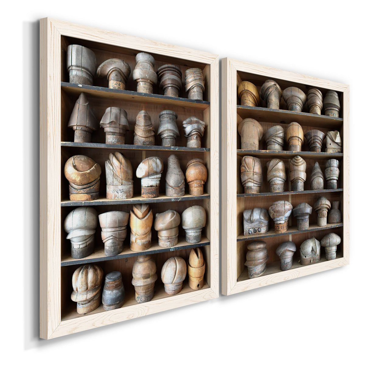 Angled view of a set of two white barnwood framed canvas prints featuring two fashion-object photography featuring shelves filled with wooden hat forms.