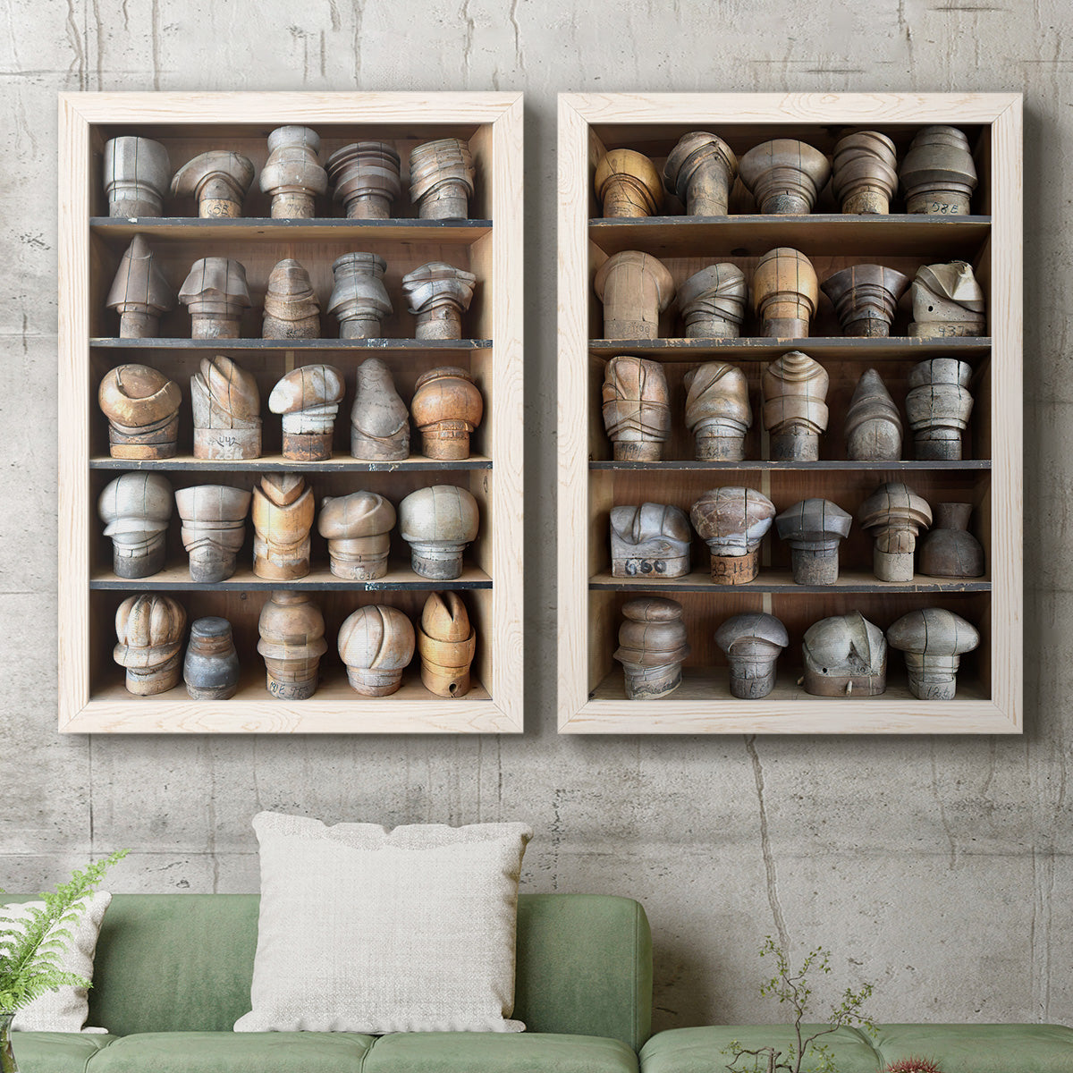 Set of two white barnwood framed canvas prints depicting a coordinated art pair of shelves filled with wooden hat forms rendered as fashion-object photography above a sofa in a modern living room.