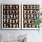 Set of two white barnwood framed canvas prints depicting rows of carved hat blocks, warm wood tones, and workshop shelving arranged across two complementary compositions above a sofa in a bright living space.
