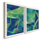 Angled view of a set of two white barnwood framed canvas prints featuring two textured geometric abstracts featuring interlocking blue and green angular forms.