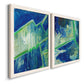 Angled view of a set of two white barnwood framed canvas prints featuring two textured geometric abstracts featuring interlocking blue and green angular forms.