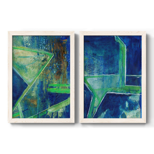 Set of two white barnwood framed canvas prints featuring two vivid geometric abstracts with angular blue green forms layered textures and deep navy fields.
