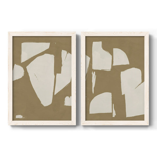 Set of two white barnwood framed canvas prints featuring two bold minimalist shape abstracts featuring irregular white cutout-like shapes on taupe grounds.