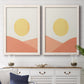 Set of two white barnwood framed canvas prints depicting a coordinated art pair of yellow suns rising over terracotta geometric hills rendered as minimalist boho landscapes above a dining room sideboard.