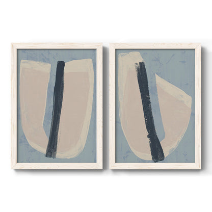 Set of two white barnwood framed canvas prints featuring two minimalist collage-style abstracts featuring single navy brush slashes across layered paper-like shapes.