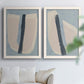 Set of two white barnwood framed canvas prints depicting muted blue green beige fields, torn-edge forms, and bold dark strokes arranged across two complementary compositions above a sofa in a bright living space.