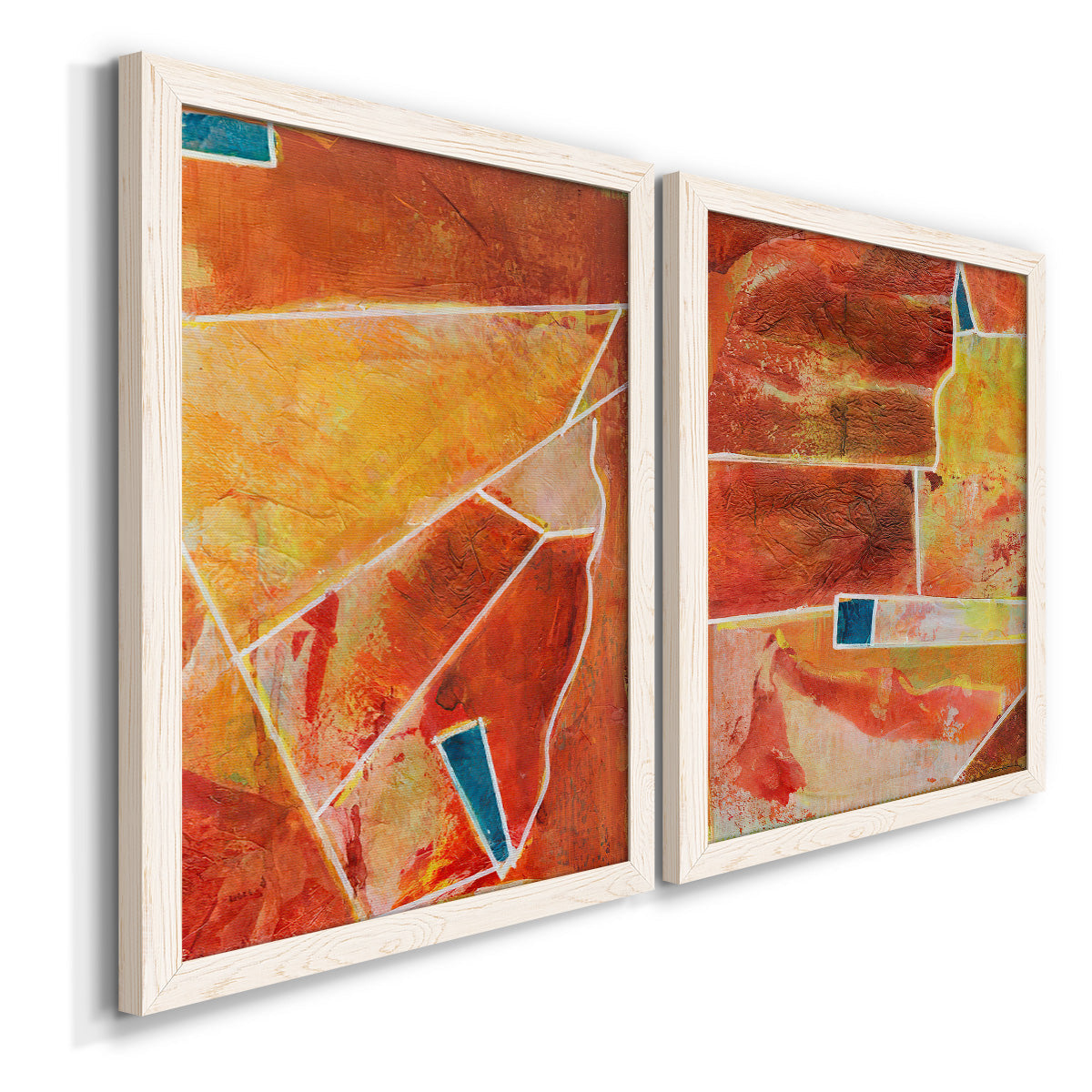 Angled view of a set of two white barnwood framed canvas prints featuring two warm geometric abstracts featuring faceted rust orange and coral geometric fields.