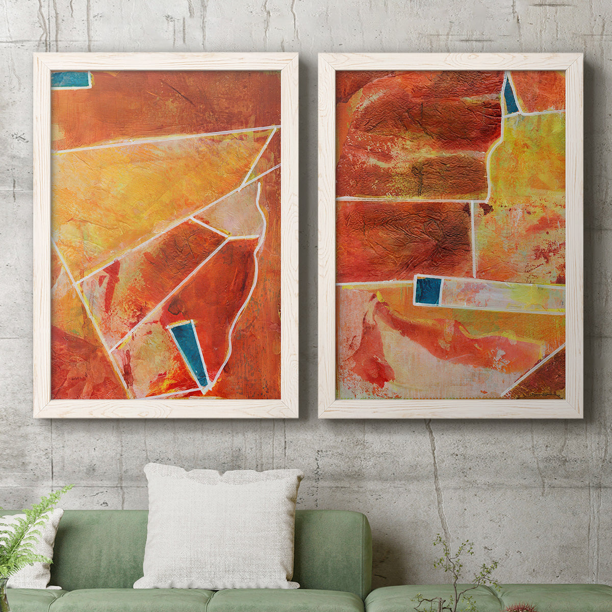 Set of two white barnwood framed canvas prints depicting a coordinated art pair of faceted rust orange and coral geometric fields rendered as warm geometric abstracts above a sofa in a modern living room.