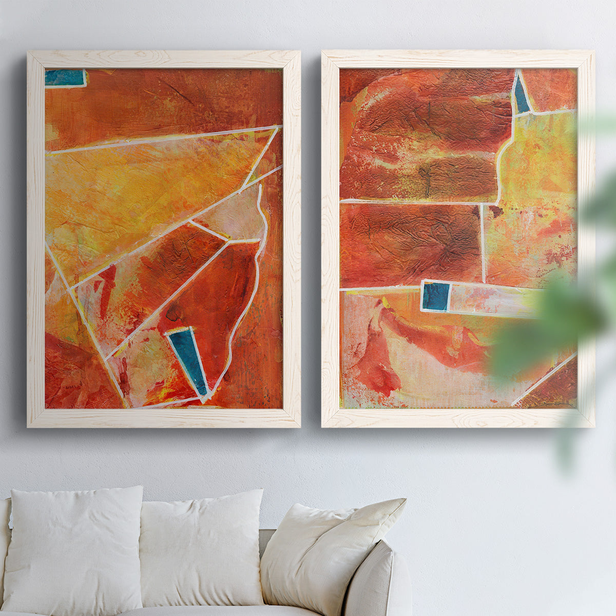 Set of two white barnwood framed canvas prints depicting white dividing lines, small turquoise accents, and layered painted texture arranged across two complementary compositions above a sofa in a bright living space.