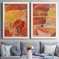Set of two white barnwood framed canvas prints depicting paired warm geometric abstracts with white dividing lines, small turquoise accents, and layered painted texture above a sofa in a contemporary living room.