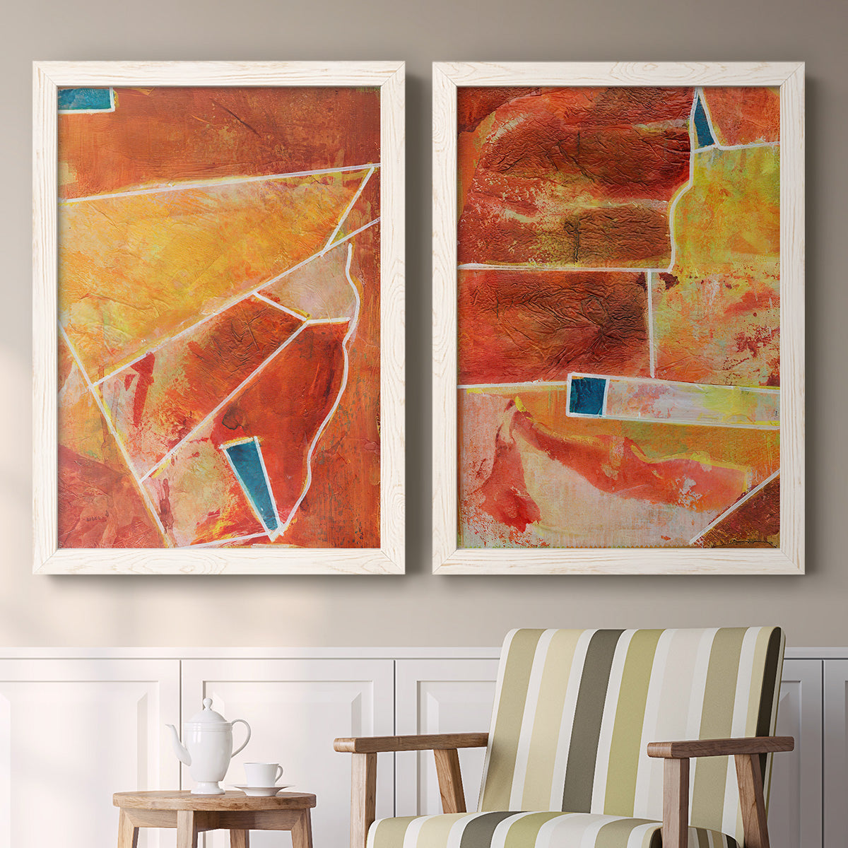 Set of two white barnwood framed canvas prints depicting two warm geometric abstracts featuring faceted rust orange and coral geometric fields above a sideboard in a cozy sitting room.