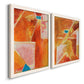 Angled view of a set of two white barnwood framed canvas prints featuring two warm geometric abstracts featuring faceted rust orange and coral geometric fields.