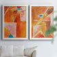 Set of two white barnwood framed canvas prints depicting white dividing lines, small turquoise accents, and layered painted texture arranged across two complementary compositions above a sofa in a bright living space.