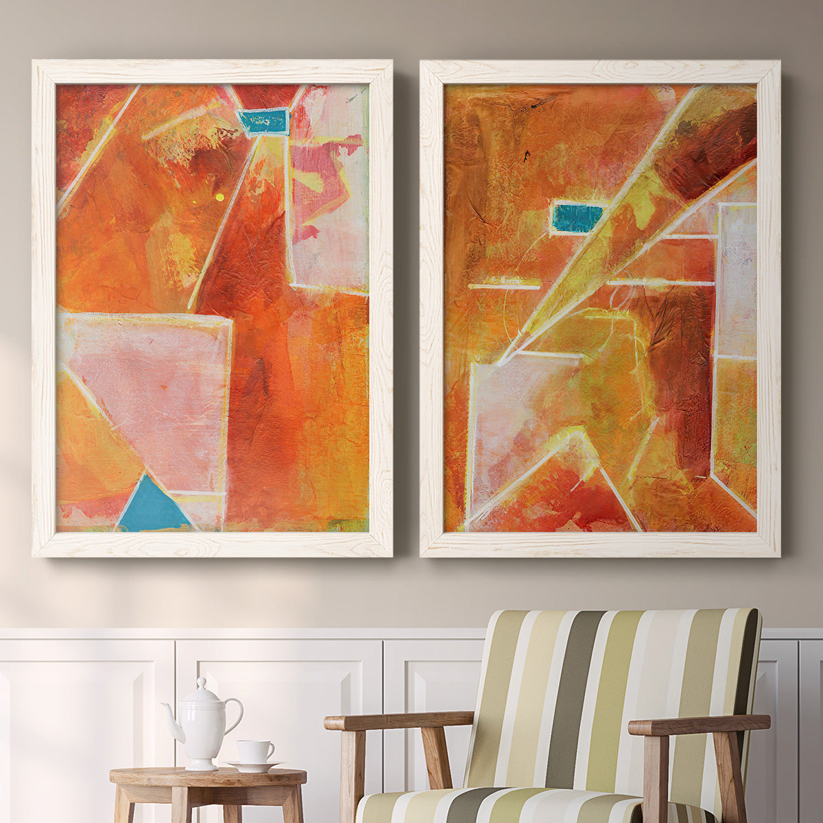 Set of two white barnwood framed canvas prints depicting two warm geometric abstracts featuring faceted rust orange and coral geometric fields above a sideboard in a cozy sitting room.