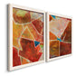Angled view of a set of two white barnwood framed canvas prints featuring two warm geometric abstracts featuring faceted rust orange and coral geometric fields.