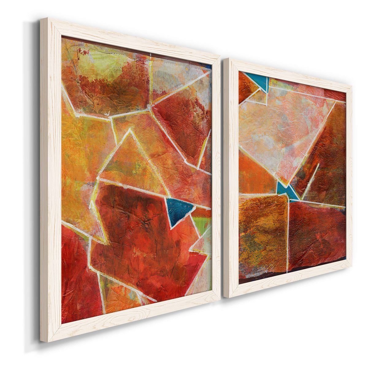 Angled view of a set of two white barnwood framed canvas prints featuring two warm geometric abstracts featuring faceted rust orange and coral geometric fields.