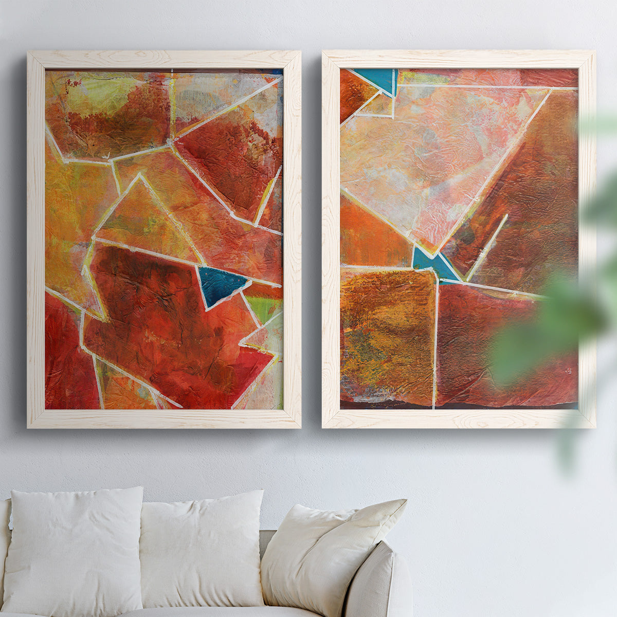 Set of two white barnwood framed canvas prints depicting white dividing lines, small turquoise accents, and layered painted texture arranged across two complementary compositions above a sofa in a bright living space.