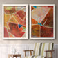 Set of two white barnwood framed canvas prints depicting two warm geometric abstracts featuring faceted rust orange and coral geometric fields above a sideboard in a cozy sitting room.
