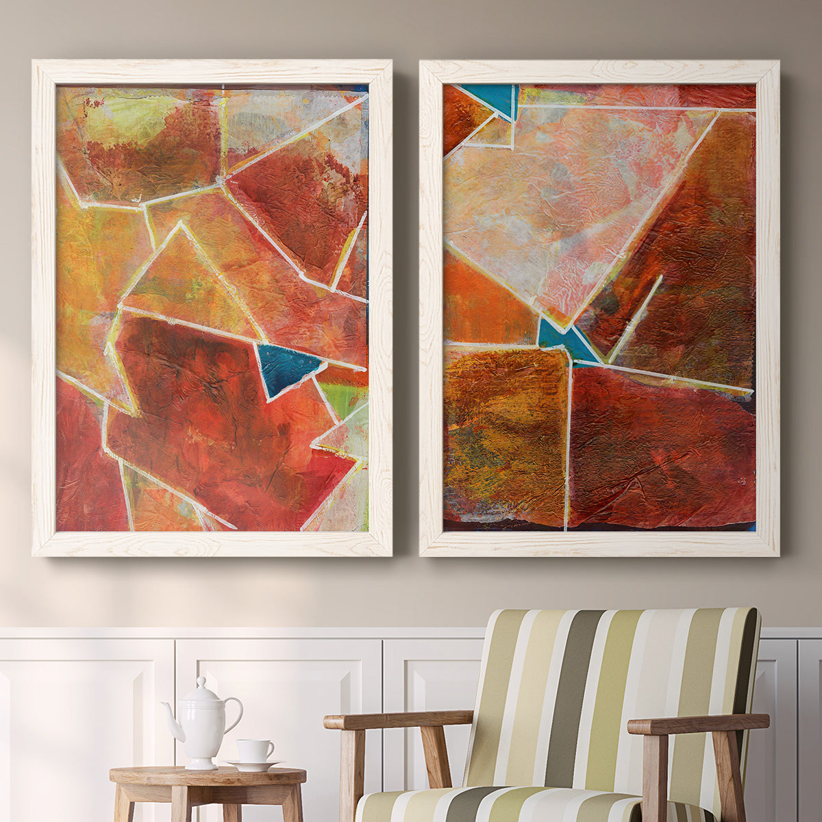 Set of two white barnwood framed canvas prints depicting two warm geometric abstracts featuring faceted rust orange and coral geometric fields above a sideboard in a cozy sitting room.