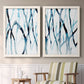 Set of two white barnwood framed canvas prints depicting two fluid organic abstracts featuring branching watercolor lines drifting across white above a sideboard in a cozy sitting room.