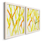 Angled view of a set of two white barnwood framed canvas prints featuring two fluid organic abstracts featuring branching watercolor lines drifting across white.
