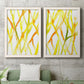 Set of two white barnwood framed canvas prints depicting a coordinated art pair of branching watercolor lines drifting across white rendered as fluid organic abstracts above a sofa in a modern living room.