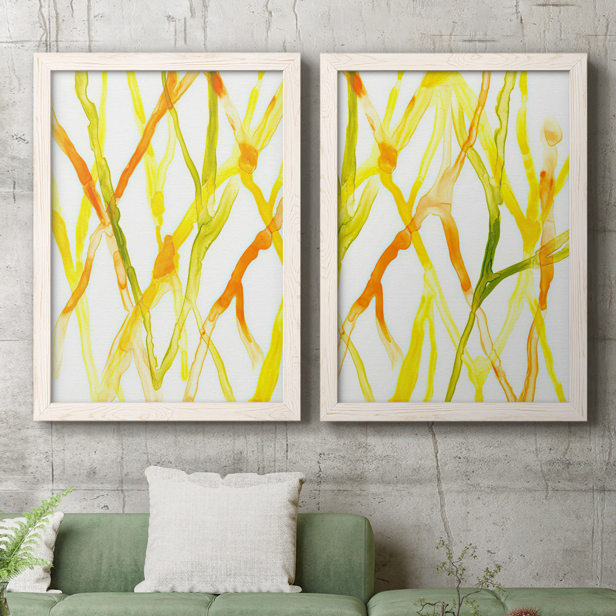 Set of two white barnwood framed canvas prints depicting a coordinated art pair of branching watercolor lines drifting across white rendered as fluid organic abstracts above a sofa in a modern living room.