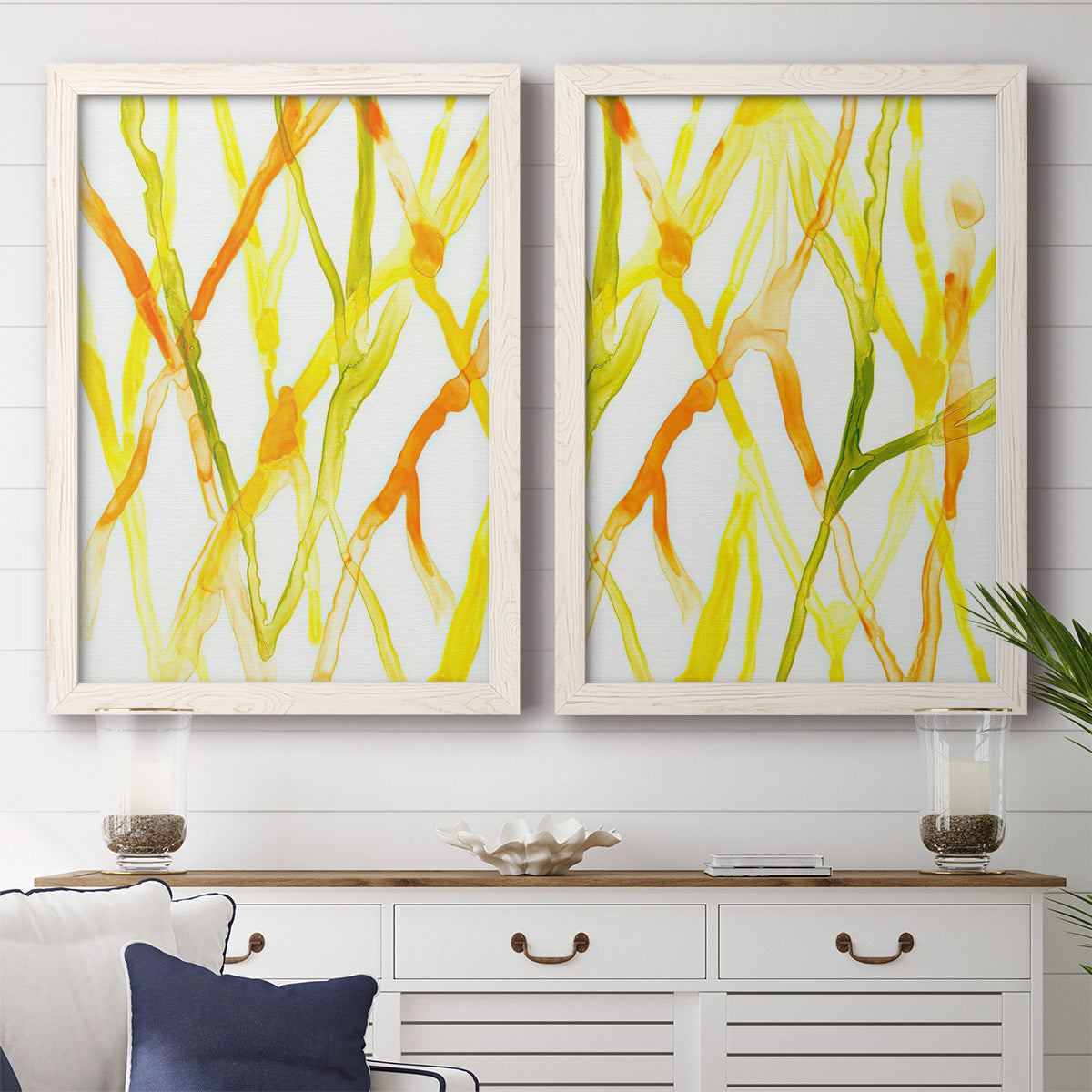 Set of two white barnwood framed canvas prints depicting a coordinated art pair of branching watercolor lines drifting across white rendered as fluid organic abstracts above a dining room sideboard.