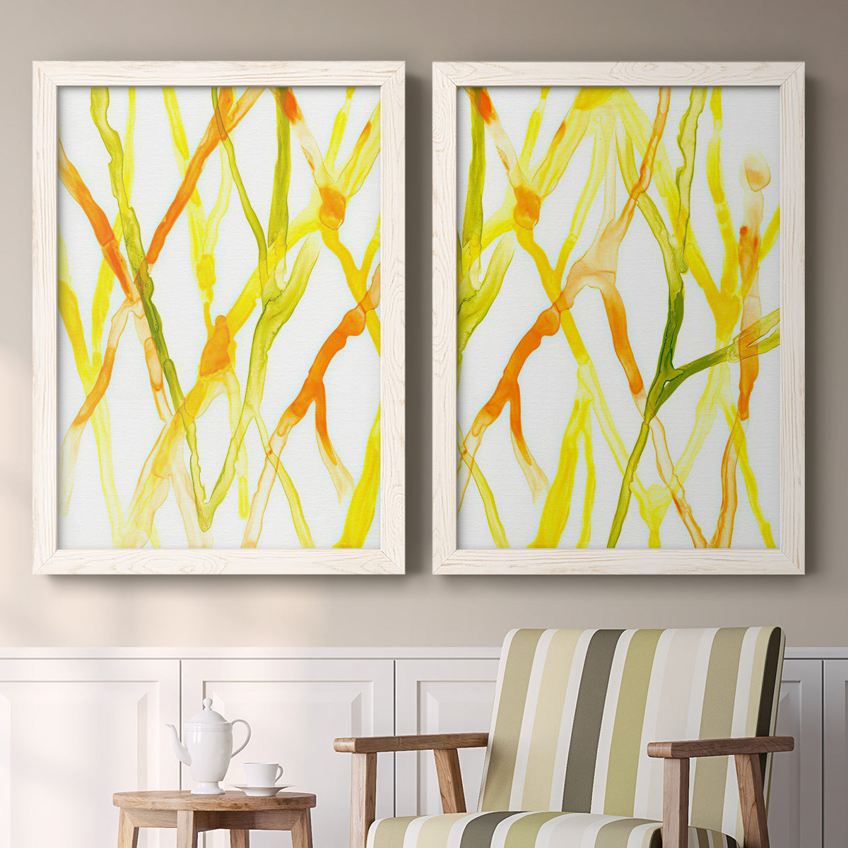 Set of two white barnwood framed canvas prints depicting two fluid organic abstracts featuring branching watercolor lines drifting across white above a sideboard in a cozy sitting room.