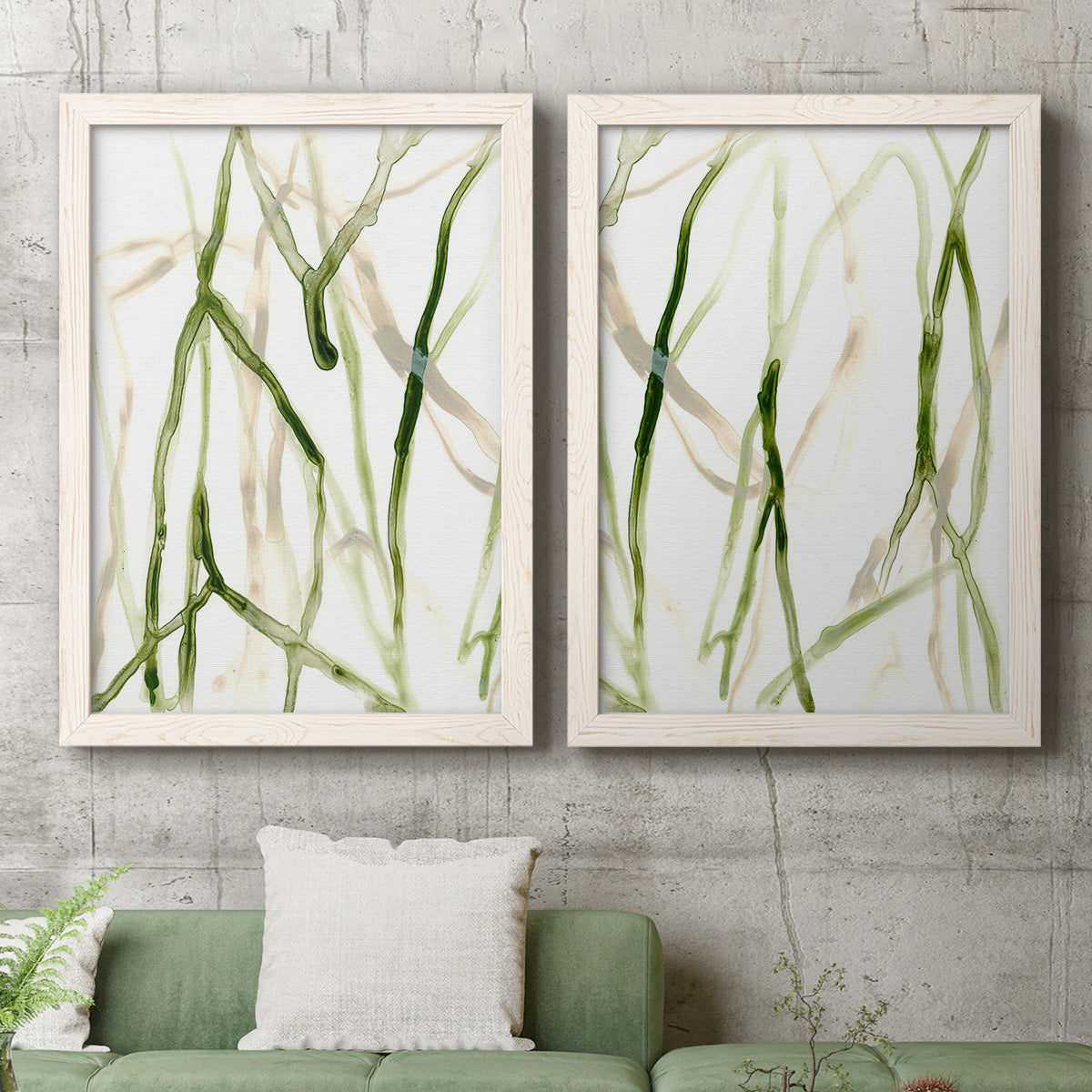 Set of two white barnwood framed canvas prints depicting a coordinated art pair of branching watercolor lines drifting across white rendered as fluid organic abstracts above a sofa in a modern living room.
