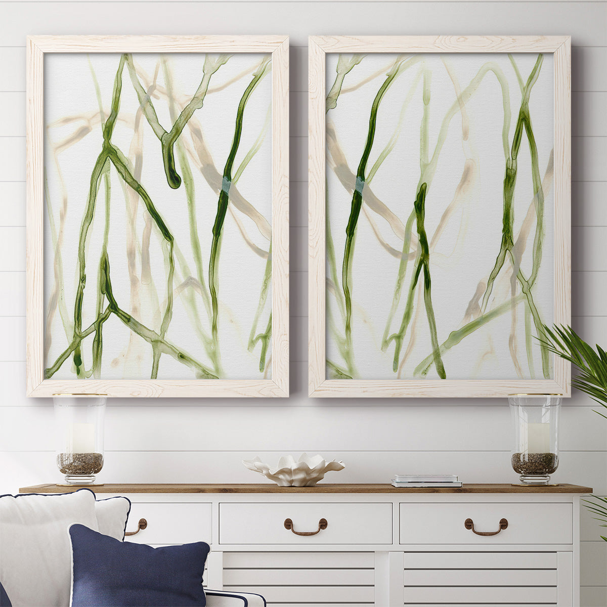 Set of two white barnwood framed canvas prints depicting a coordinated art pair of branching watercolor lines drifting across white rendered as fluid organic abstracts above a dining room sideboard.