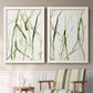 Set of two white barnwood framed canvas prints depicting two fluid organic abstracts featuring branching watercolor lines drifting across white above a sideboard in a cozy sitting room.