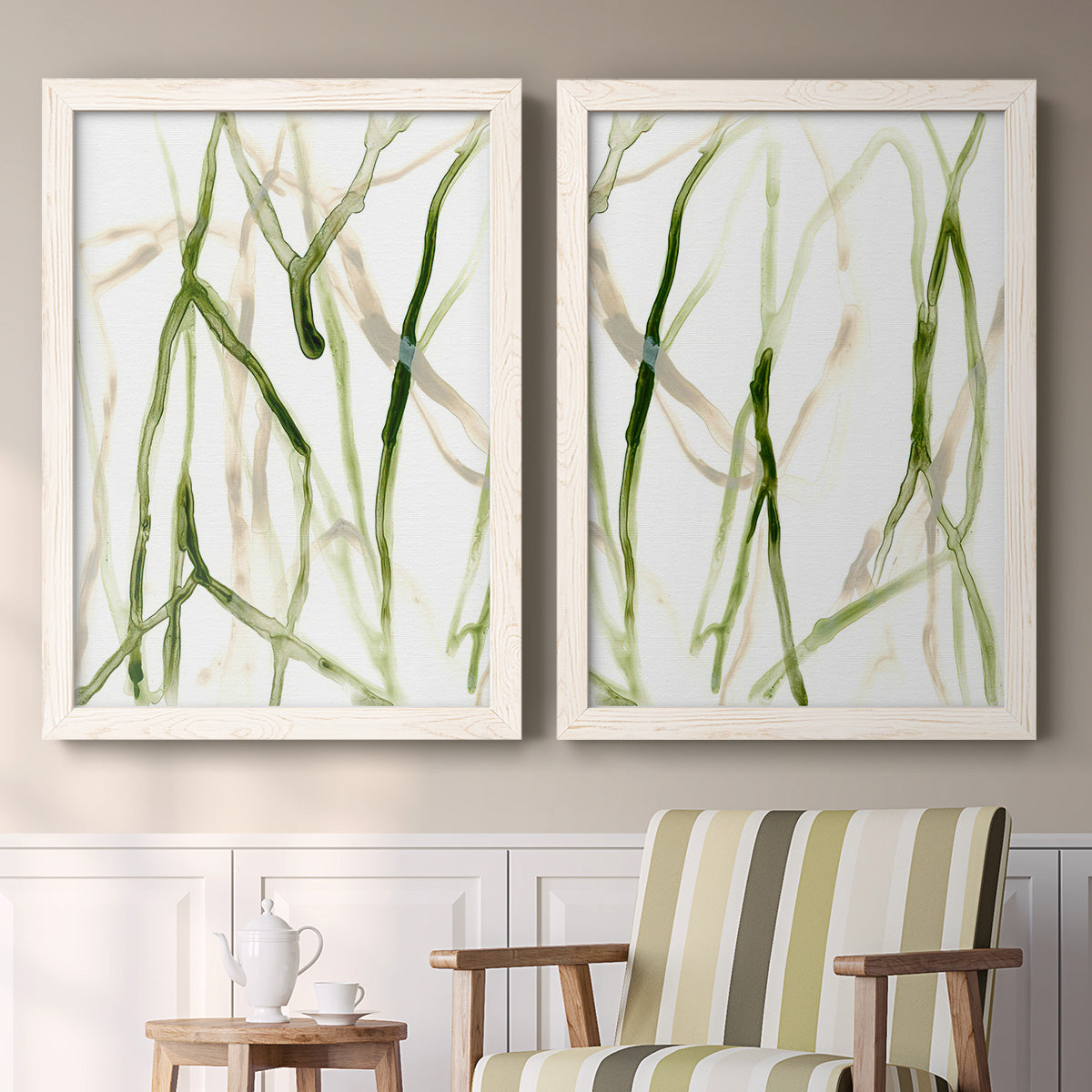Set of two white barnwood framed canvas prints depicting two fluid organic abstracts featuring branching watercolor lines drifting across white above a sideboard in a cozy sitting room.
