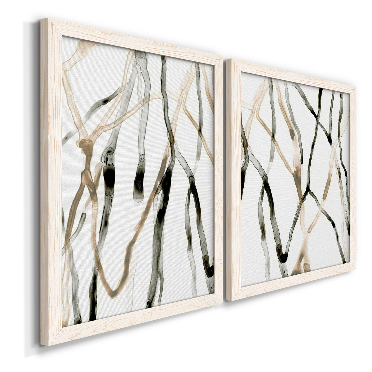Angled view of a set of two white barnwood framed canvas prints featuring two fluid organic abstracts featuring branching watercolor lines drifting across white.