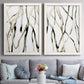 Set of two white barnwood framed canvas prints depicting paired fluid organic abstracts with slender vein-like strokes, transparent overlaps, and open negative space above a sofa in a contemporary living room.