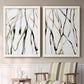 Set of two white barnwood framed canvas prints depicting two fluid organic abstracts featuring branching watercolor lines drifting across white above a sideboard in a cozy sitting room.