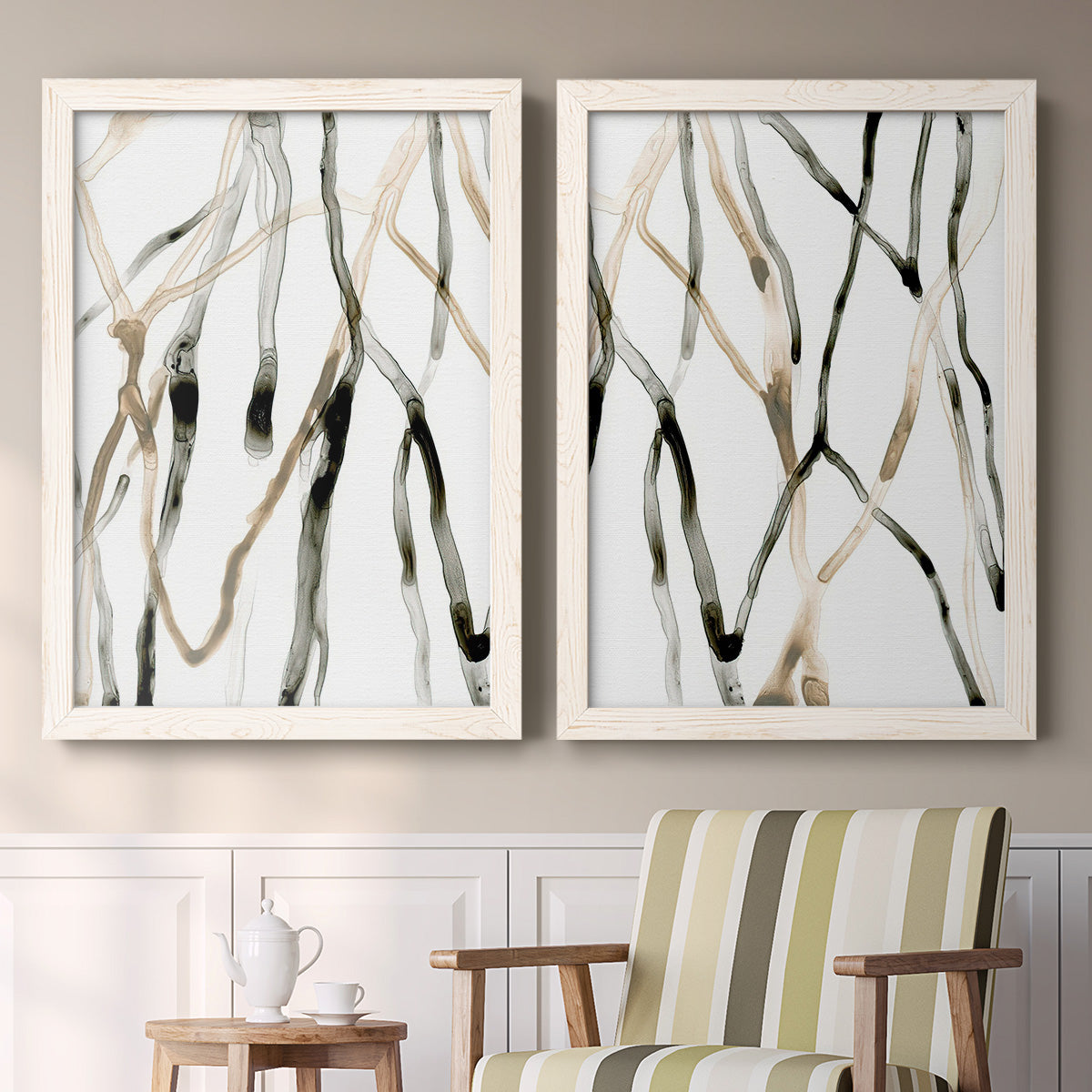 Set of two white barnwood framed canvas prints depicting two fluid organic abstracts featuring branching watercolor lines drifting across white above a sideboard in a cozy sitting room.