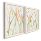 Angled view of a set of two white barnwood framed canvas prints featuring two fluid organic abstracts featuring branching watercolor lines drifting across white.