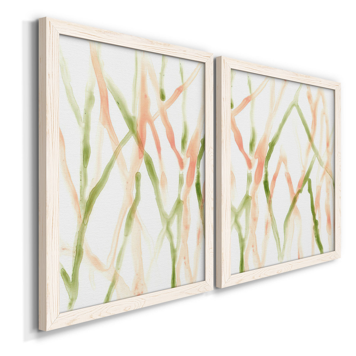 Angled view of a set of two white barnwood framed canvas prints featuring two fluid organic abstracts featuring branching watercolor lines drifting across white.