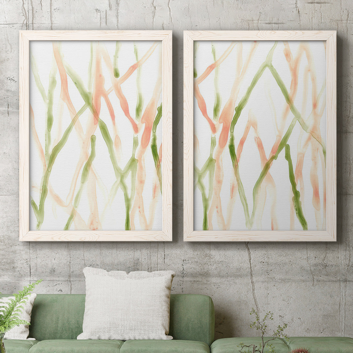 Set of two white barnwood framed canvas prints depicting a coordinated art pair of branching watercolor lines drifting across white rendered as fluid organic abstracts above a sofa in a modern living room.