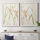 Set of two white barnwood framed canvas prints depicting a coordinated art pair of branching watercolor lines drifting across white rendered as fluid organic abstracts above a dining room sideboard.