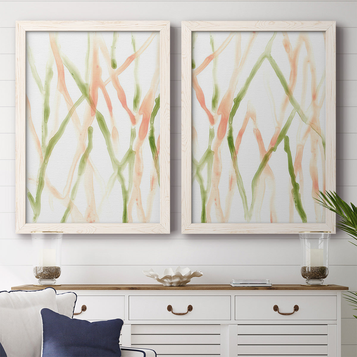 Set of two white barnwood framed canvas prints depicting a coordinated art pair of branching watercolor lines drifting across white rendered as fluid organic abstracts above a dining room sideboard.