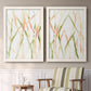 Set of two white barnwood framed canvas prints depicting two fluid organic abstracts featuring branching watercolor lines drifting across white above a sideboard in a cozy sitting room.
